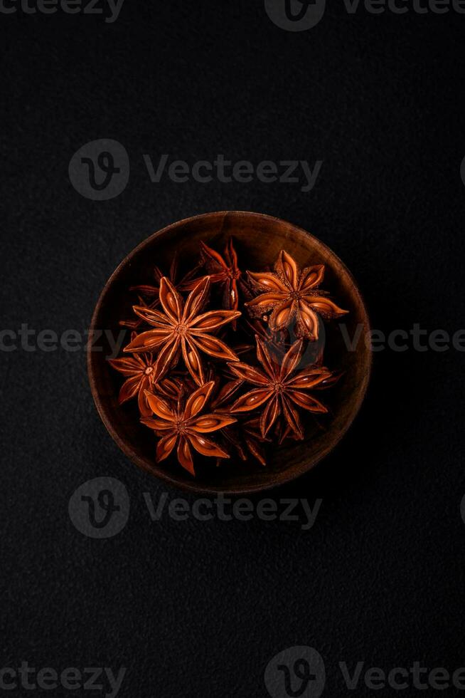 Star shaped spice star anise in a wooden round bowl photo