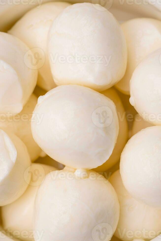 Delicious fresh mozzarella cheese in the form of small balls with salt and spices photo