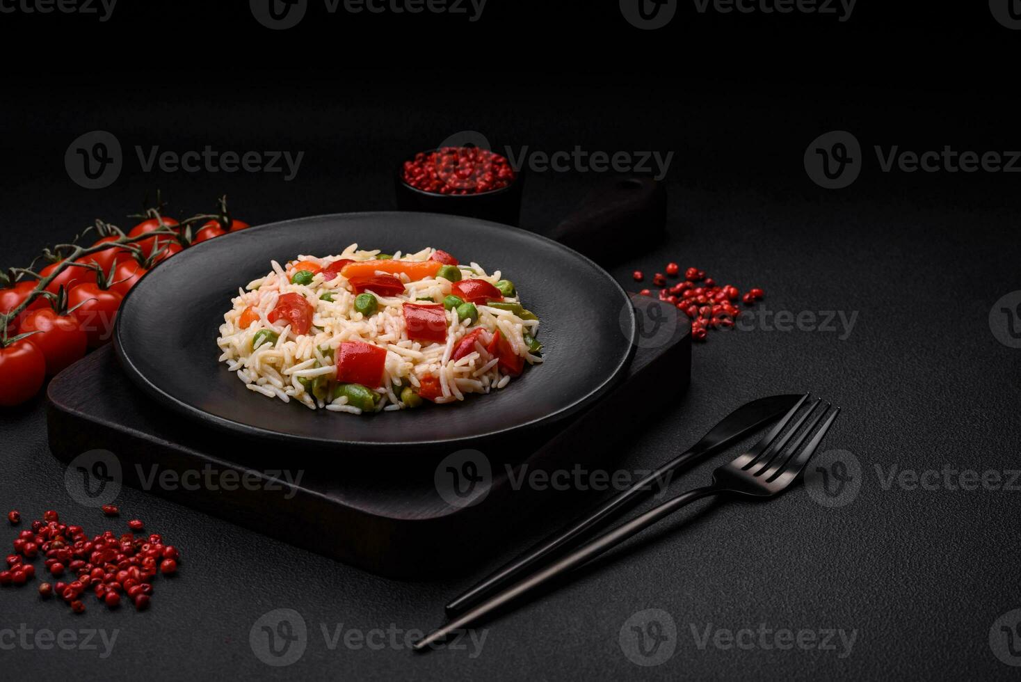 Delicious boiled rice with peppers, peas, asparagus beans and carrots photo