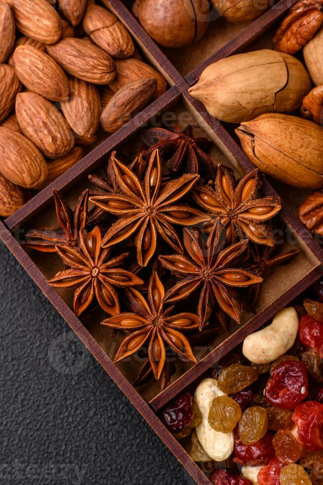 Mix of roasted macadamia nuts, cashews, pecans, almonds, raisins and dry berries photo