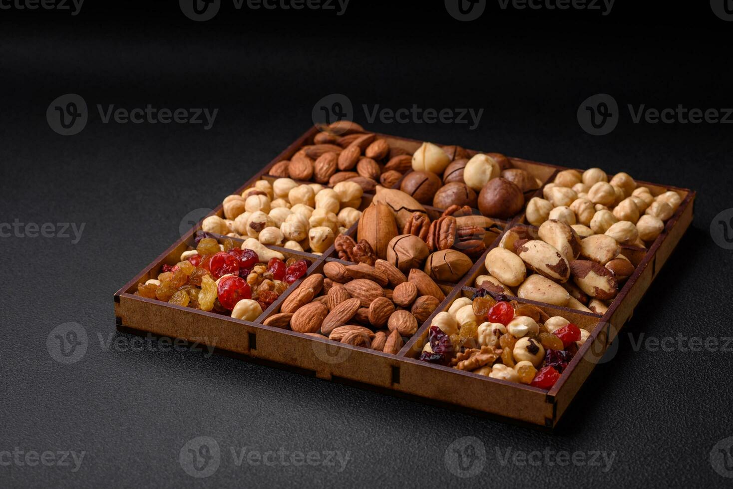 Mix of roasted macadamia nuts, cashews, pecans, almonds, raisins and dry berries photo