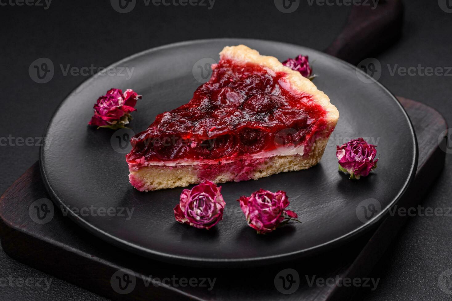 Delicious fragrant sweet pie with cherry berries on a ceramic plate photo