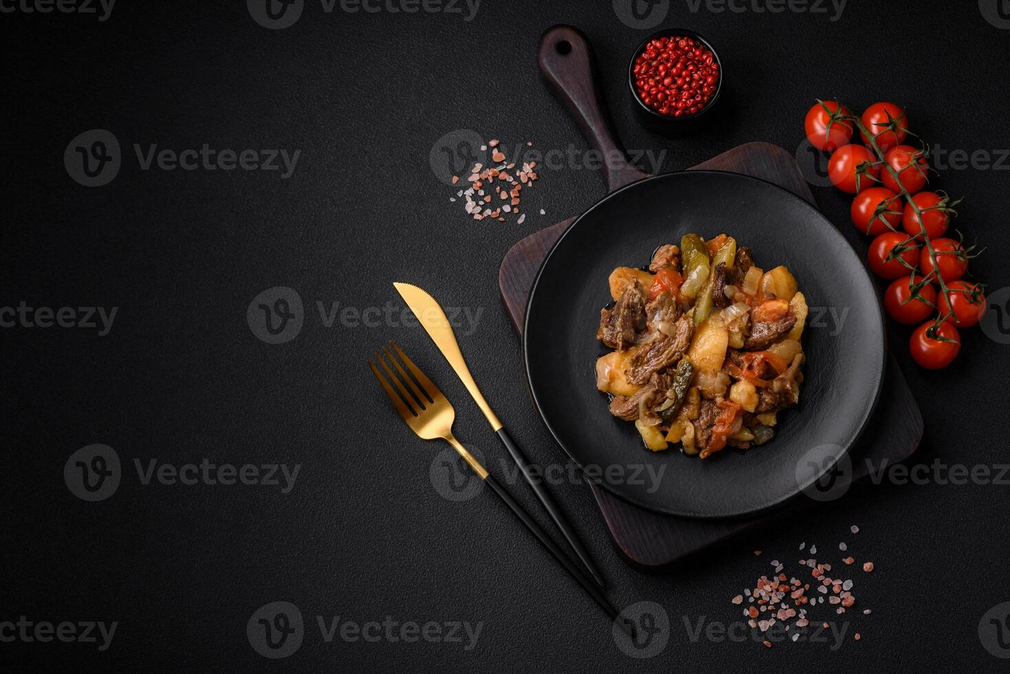 Delicious stew with potatoes, tomatoes, beef, onions and carrots photo