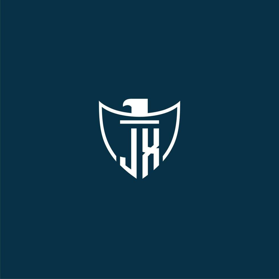 JX initial monogram logo for shield with eagle image vector design