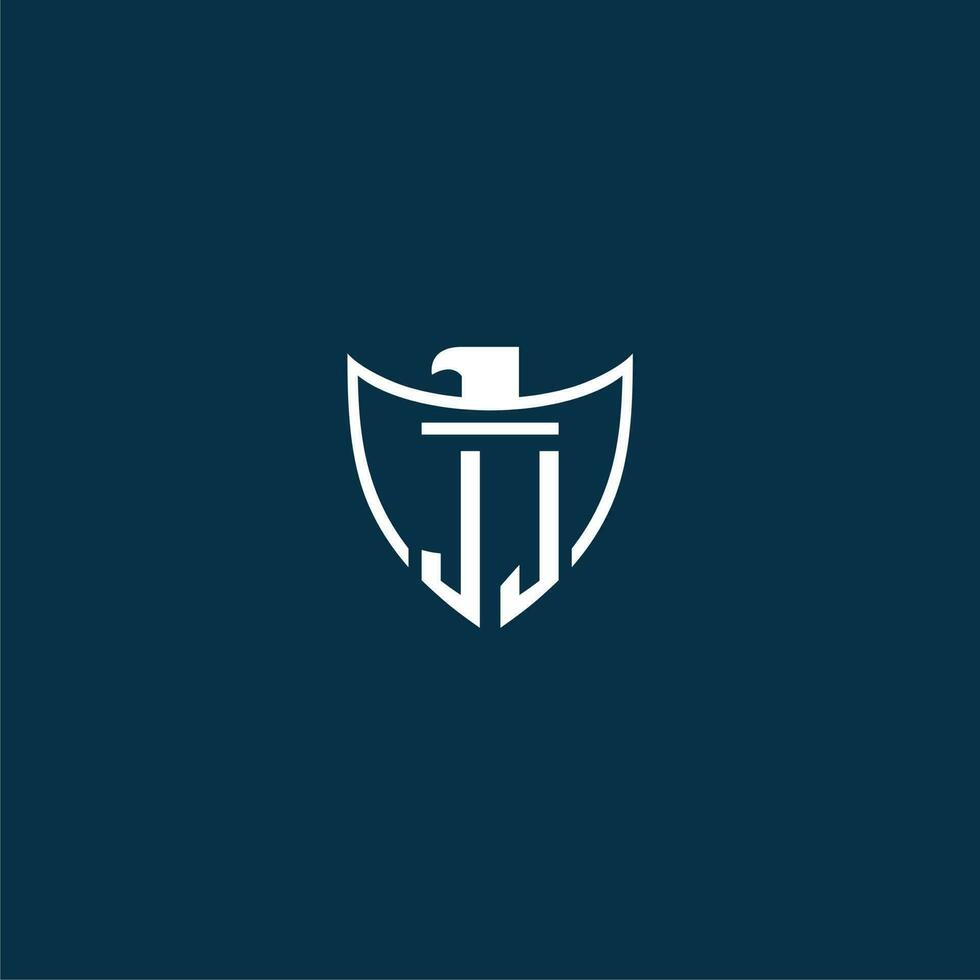 JJ initial monogram logo for shield with eagle image vector design