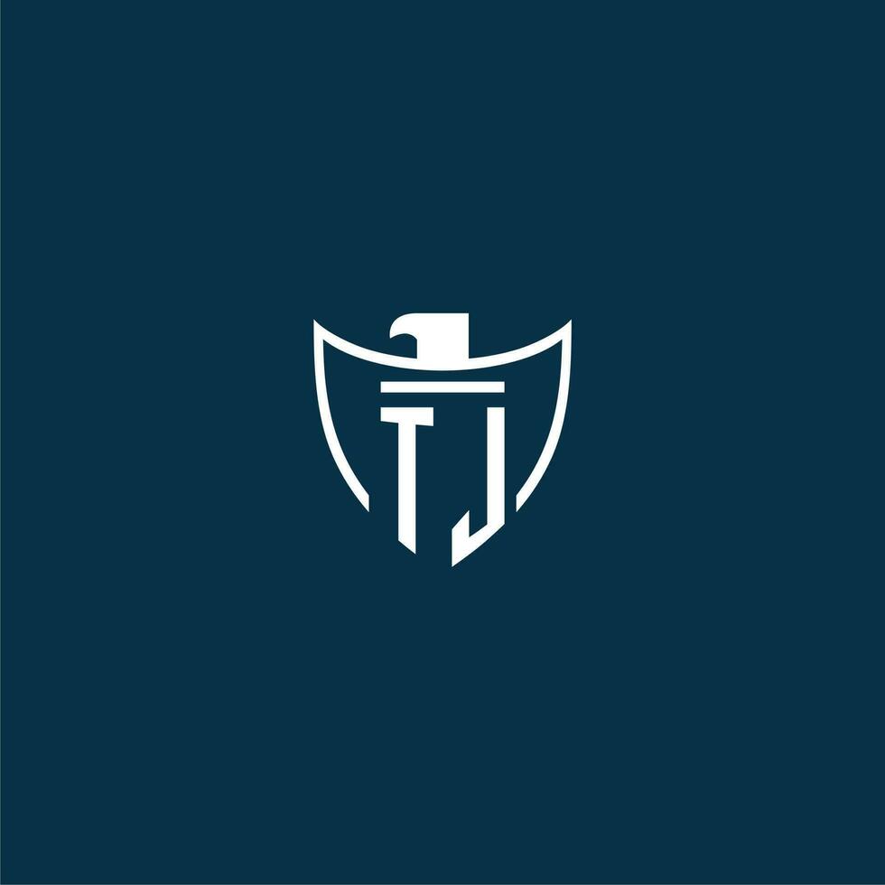 TJ initial monogram logo for shield with eagle image vector design