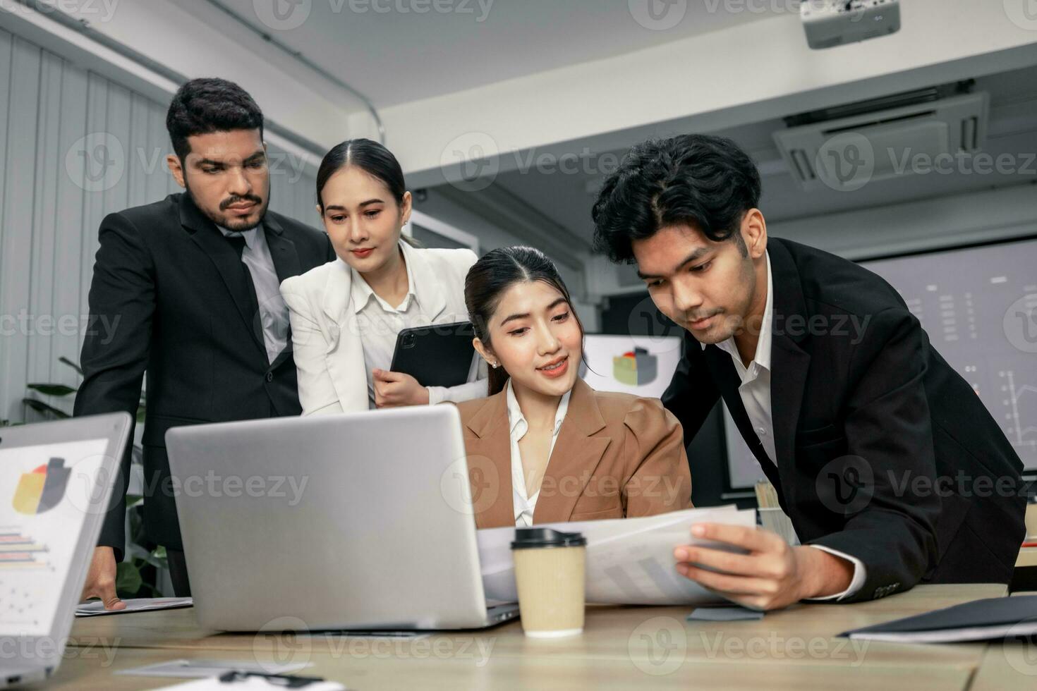 Financial advisors collaborate to assess a company's financial performance using data from its operational activities. Team members work together in a discussions meeting to develop a business plan. photo