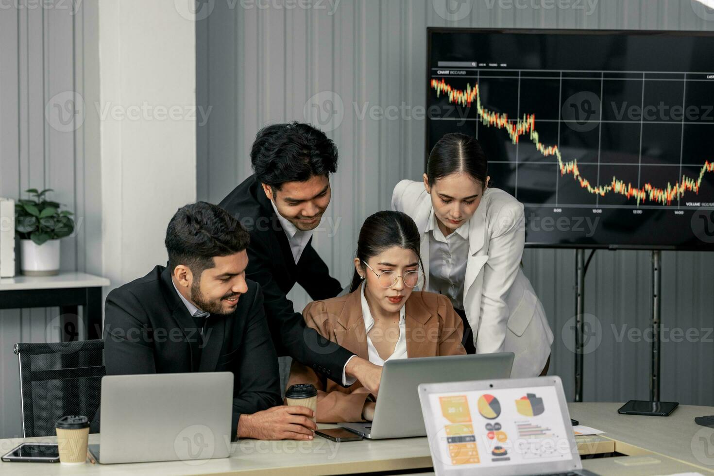 Financial advisors collaborate to assess a company's financial performance using data from its operational activities. Team members work together in a discussions meeting to develop a business plan. photo