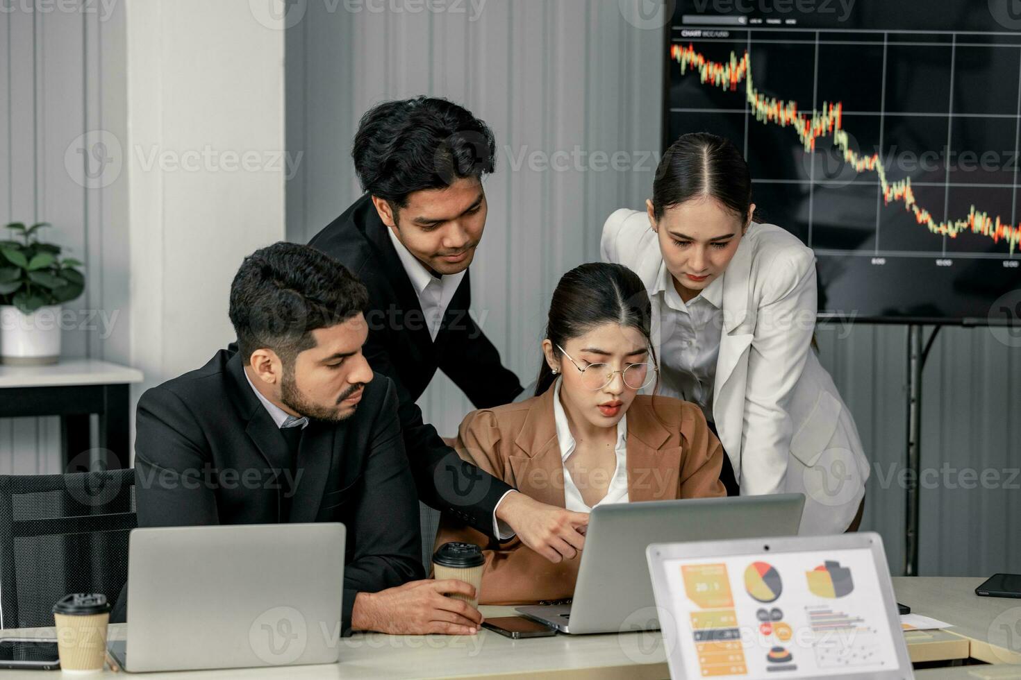Financial advisors collaborate to assess a company's financial performance using data from its operational activities. Team members work together in a discussions meeting to develop a business plan. photo
