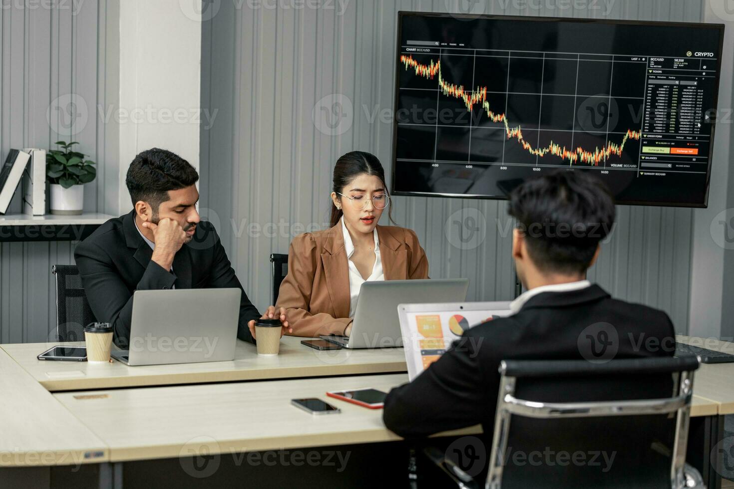 Financial advisors collaborate to assess a company's financial performance using data from its operational activities. Team members work together in a discussions meeting to develop a business plan. photo