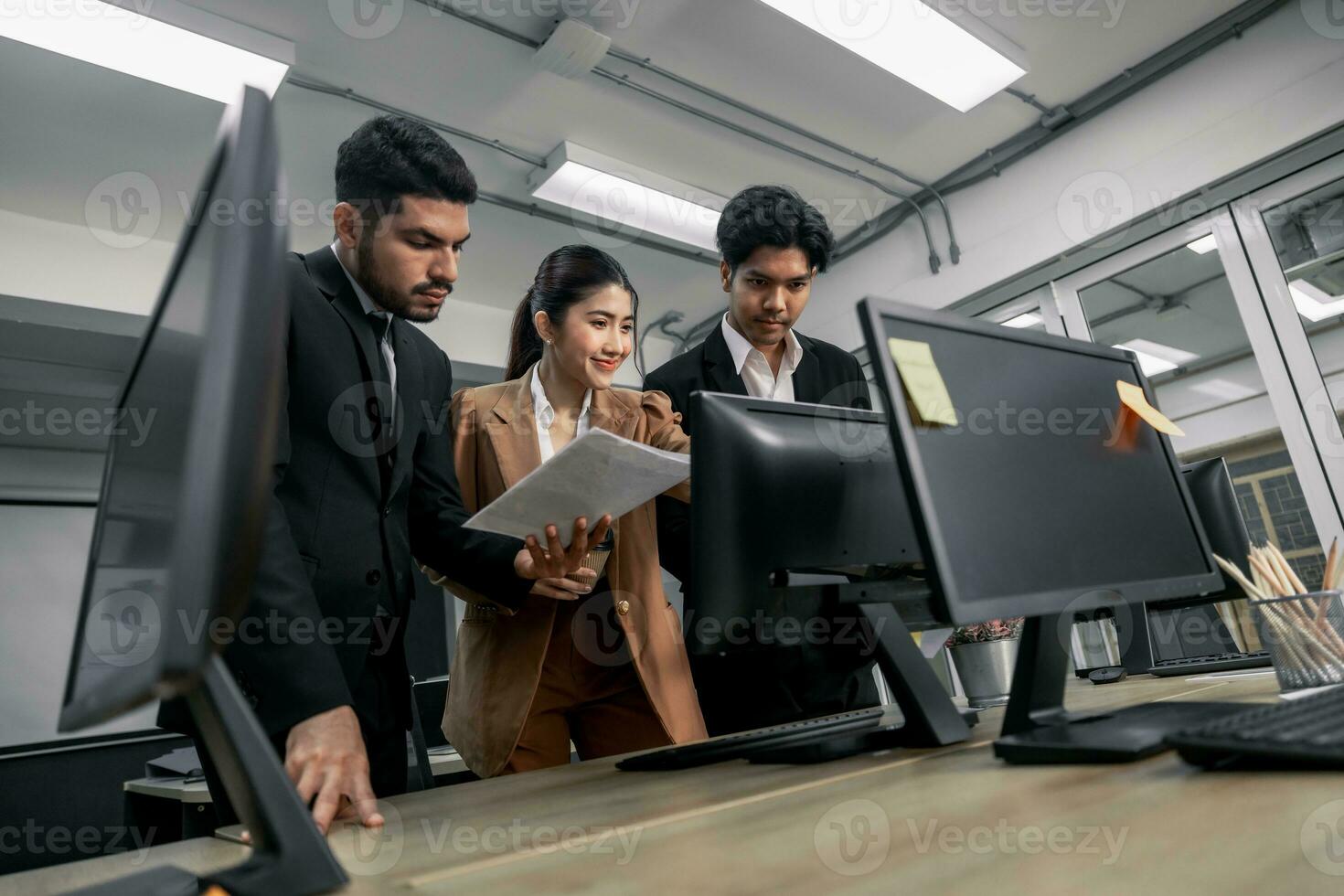 Financial advisors collaborate to assess a company's financial performance using data from its operational activities. Team members work together in a discussions meeting to develop a business plan. photo