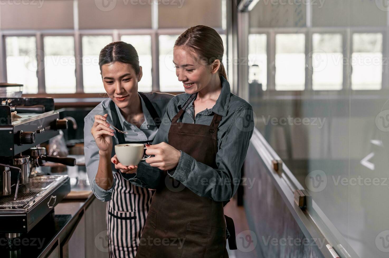 Young adult coffee makers work with skilled baristas to create menus. Using a coffee machine to make hot and cold coffee. Experiment with grinding and blending, including adding milk foam on top. photo