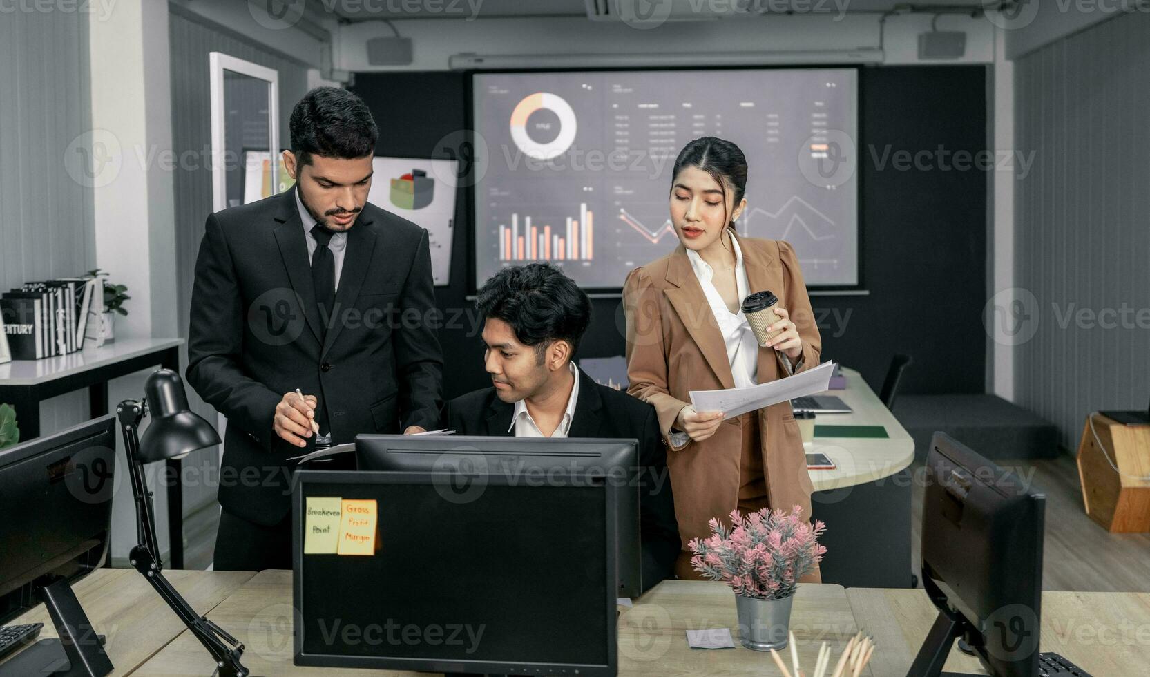 Financial advisors collaborate to assess a company's financial performance using data from its operational activities. Team members work together in a discussions meeting to develop a business plan. photo