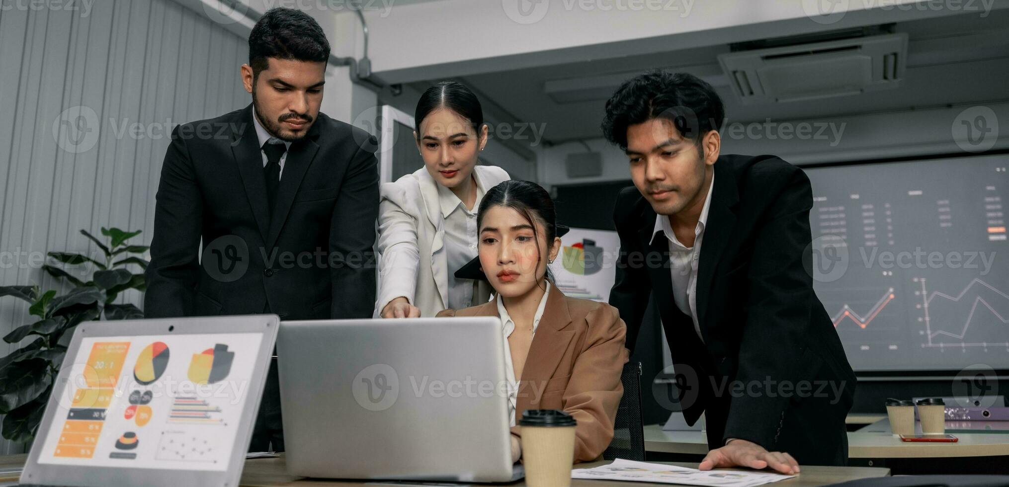 Financial advisors collaborate to assess a company's financial performance using data from its operational activities. Team members work together in a discussions meeting to develop a business plan. photo