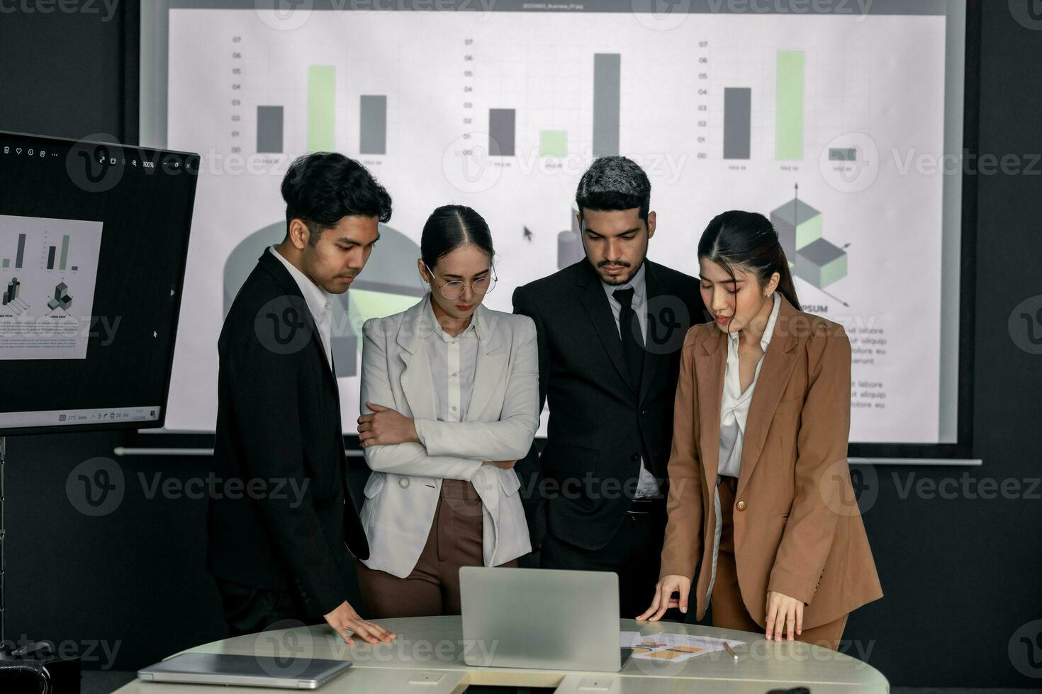 Financial advisors collaborate to assess a company's financial performance using data from its operational activities. Team members work together in a discussions meeting to develop a business plan. photo