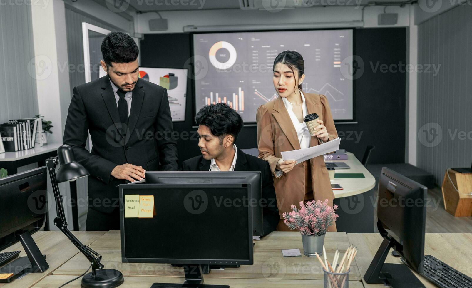 Financial advisors collaborate to assess a company's financial performance using data from its operational activities. Team members work together in a discussions meeting to develop a business plan. photo