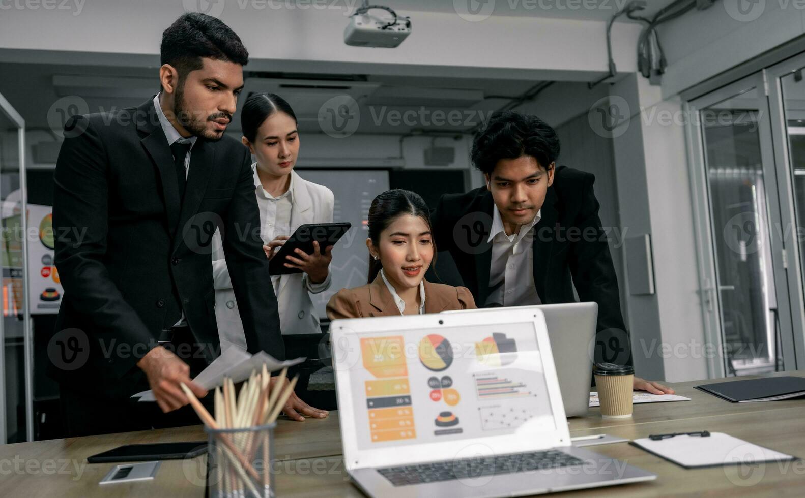 Financial advisors collaborate to assess a company's financial performance using data from its operational activities. Team members work together in a discussions meeting to develop a business plan. photo
