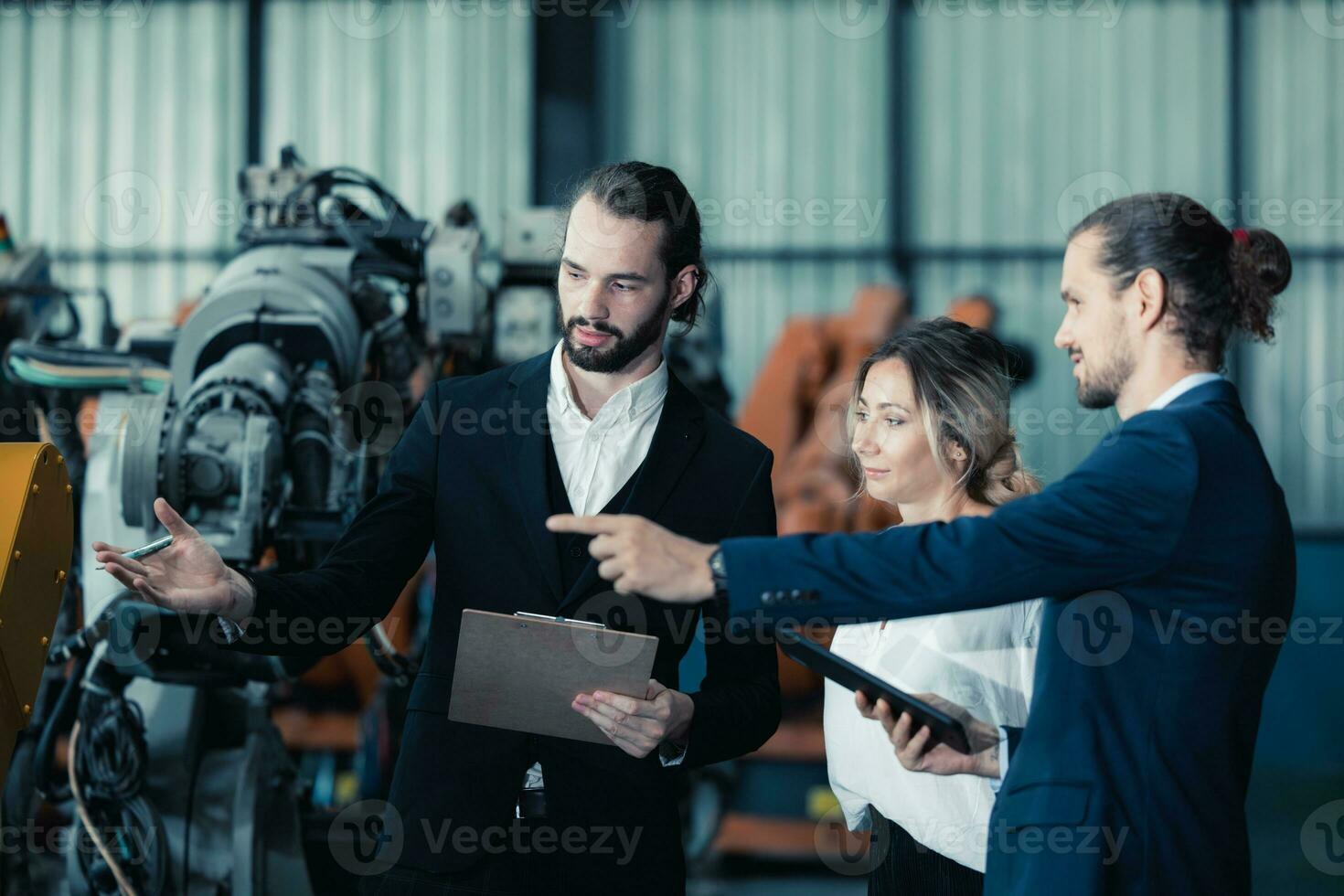 Robotic factory owner explain, discuss functionality and performance of robot systems with client. Answering questions about after-sales service. Price negotiation. Developing long-term relationships photo
