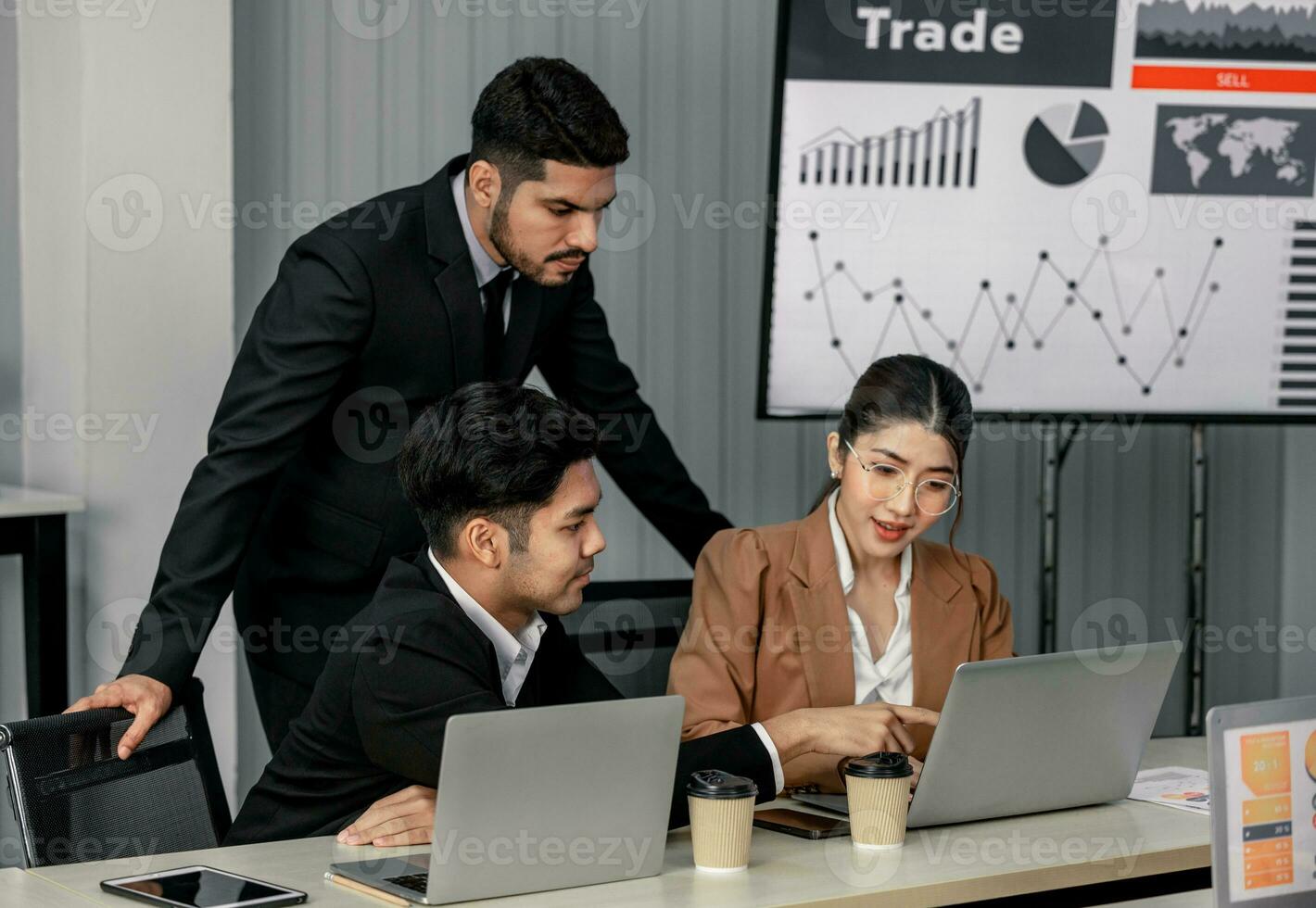 Financial advisors collaborate to assess a company's financial performance using data from its operational activities. Team members work together in a discussions meeting to develop a business plan. photo