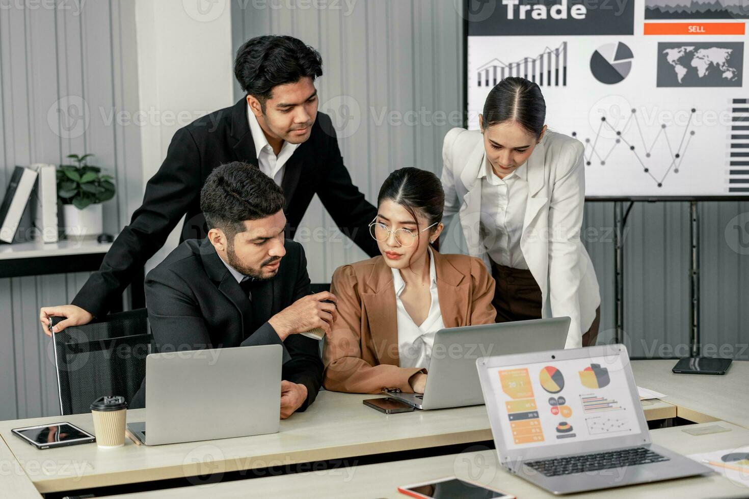 Financial advisors collaborate to assess a company's financial performance using data from its operational activities. Team members work together in a discussions meeting to develop a business plan. photo