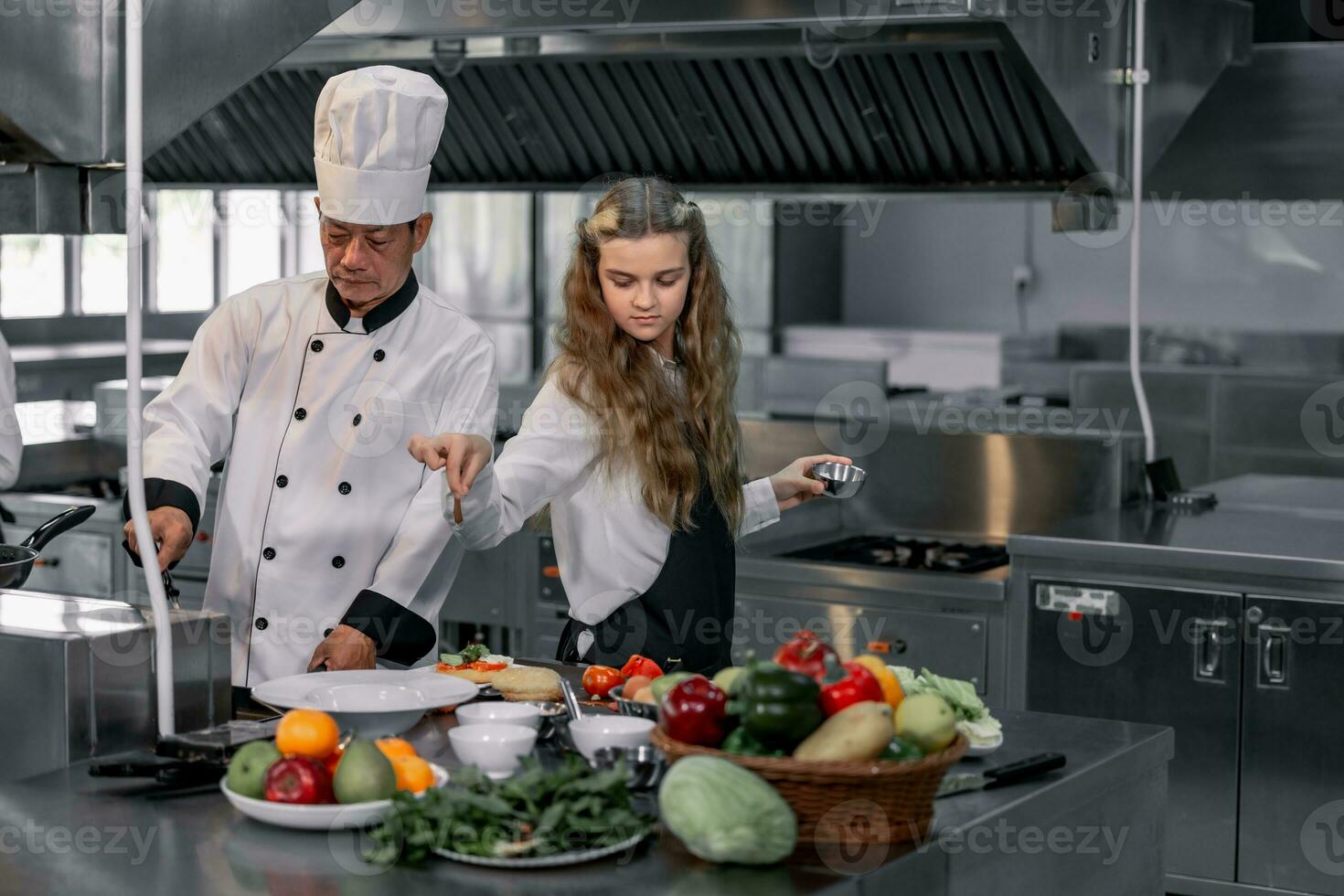 Teenagers learn from expert chefs at culinary school to prepare ingredients and create a variety of tasty meals. A practical activity connected their senses of taste and smell is making hamburgers. photo