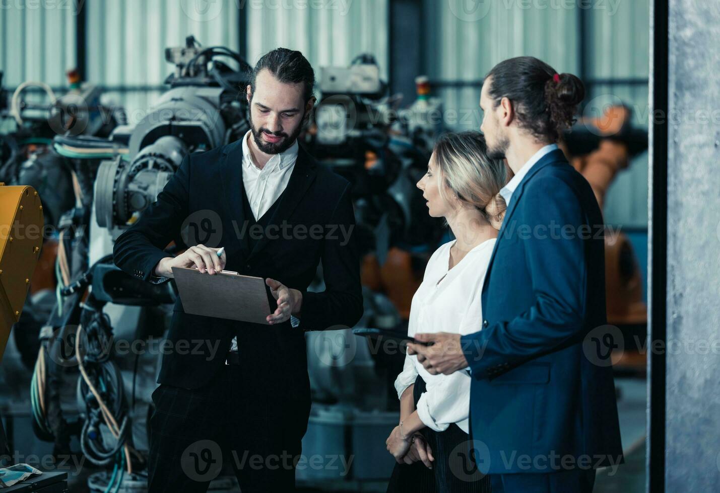 Robotic factory owner explain, discuss functionality and performance of robot systems with client. Answering questions about after-sales service. Price negotiation. Developing long-term relationships photo