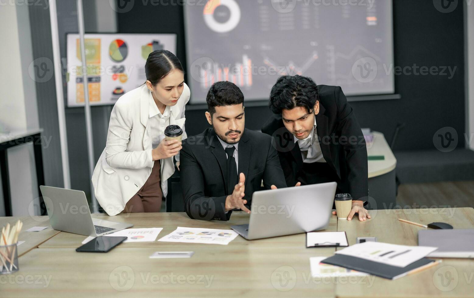 Financial advisors collaborate to assess a company's financial performance using data from its operational activities. Team members work together in a discussions meeting to develop a business plan. photo