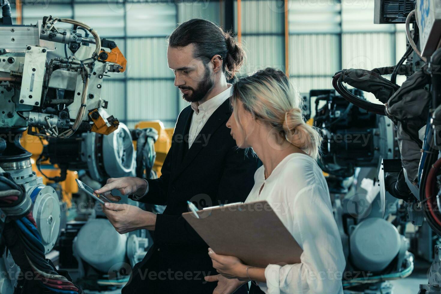 Robotic factory owner explain, discuss functionality and performance of robot systems with client. Answering questions about after-sales service. Price negotiation. Developing long-term relationships photo