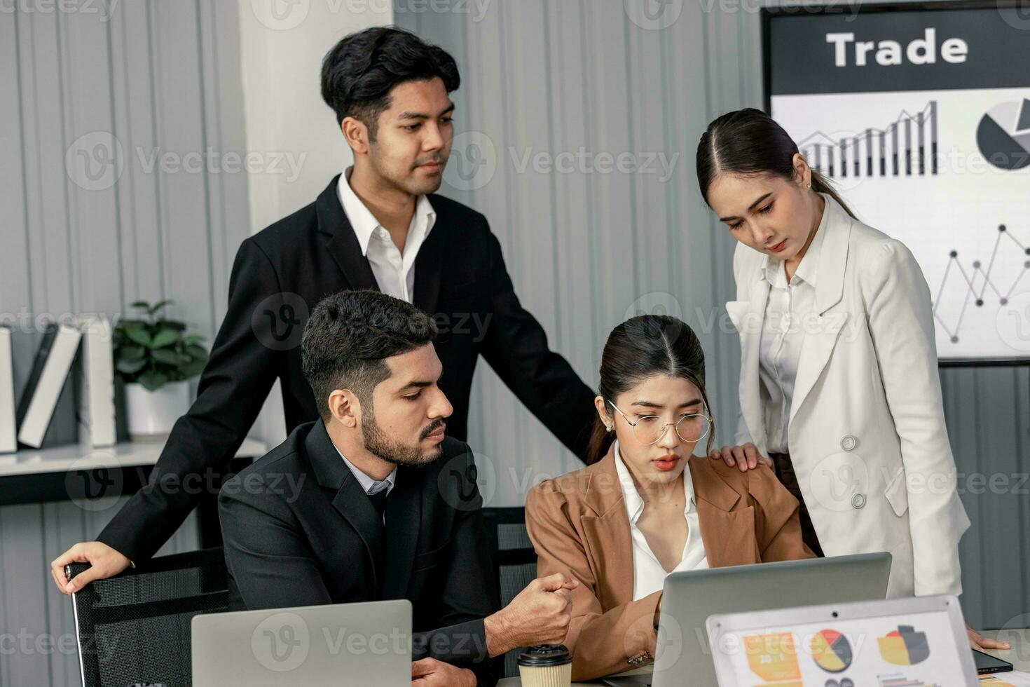 Financial advisors collaborate to assess a company's financial performance using data from its operational activities. Team members work together in a discussions meeting to develop a business plan. photo