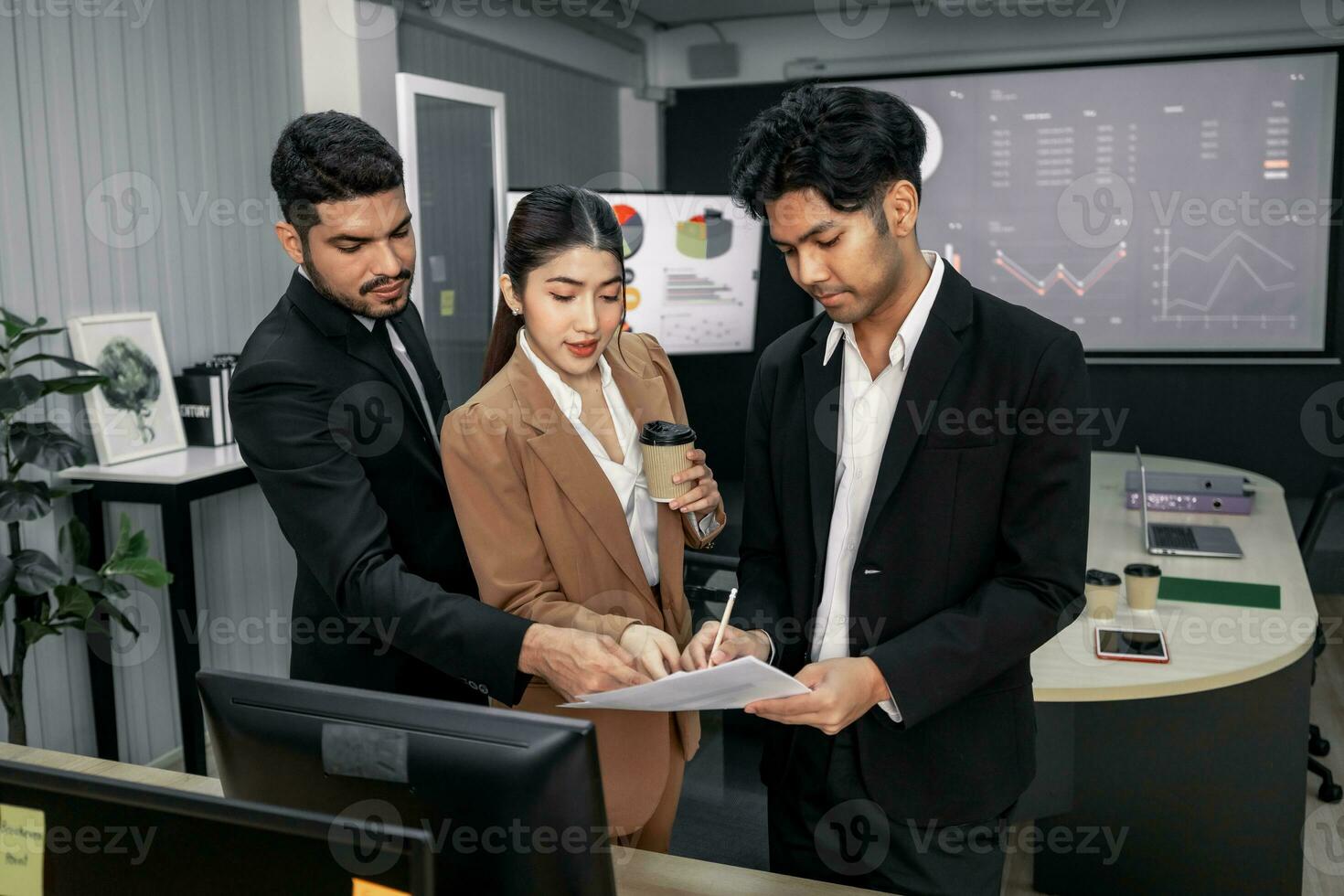 Financial advisors collaborate to assess a company's financial performance using data from its operational activities. Team members work together in a discussions meeting to develop a business plan. photo