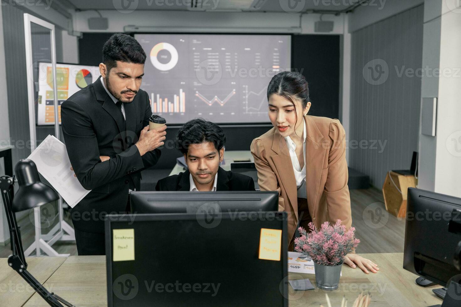 Financial advisors collaborate to assess a company's financial performance using data from its operational activities. Team members work together in a discussions meeting to develop a business plan. photo