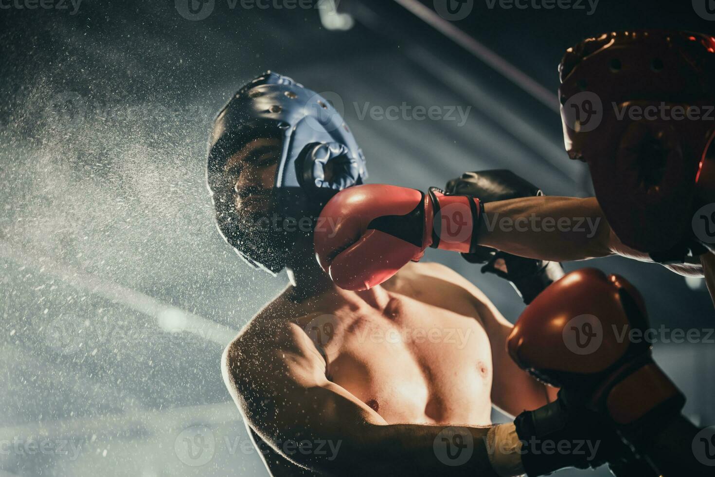 Boxer use various punch combinations, including the jab, hook, uppercut, cross, swing, straight. Getting in close to make opponent on ropes and knockout. Boxing champions win the round in boxing ring photo