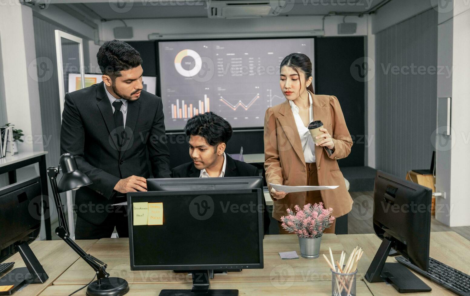 Financial advisors collaborate to assess a company's financial performance using data from its operational activities. Team members work together in a discussions meeting to develop a business plan. photo