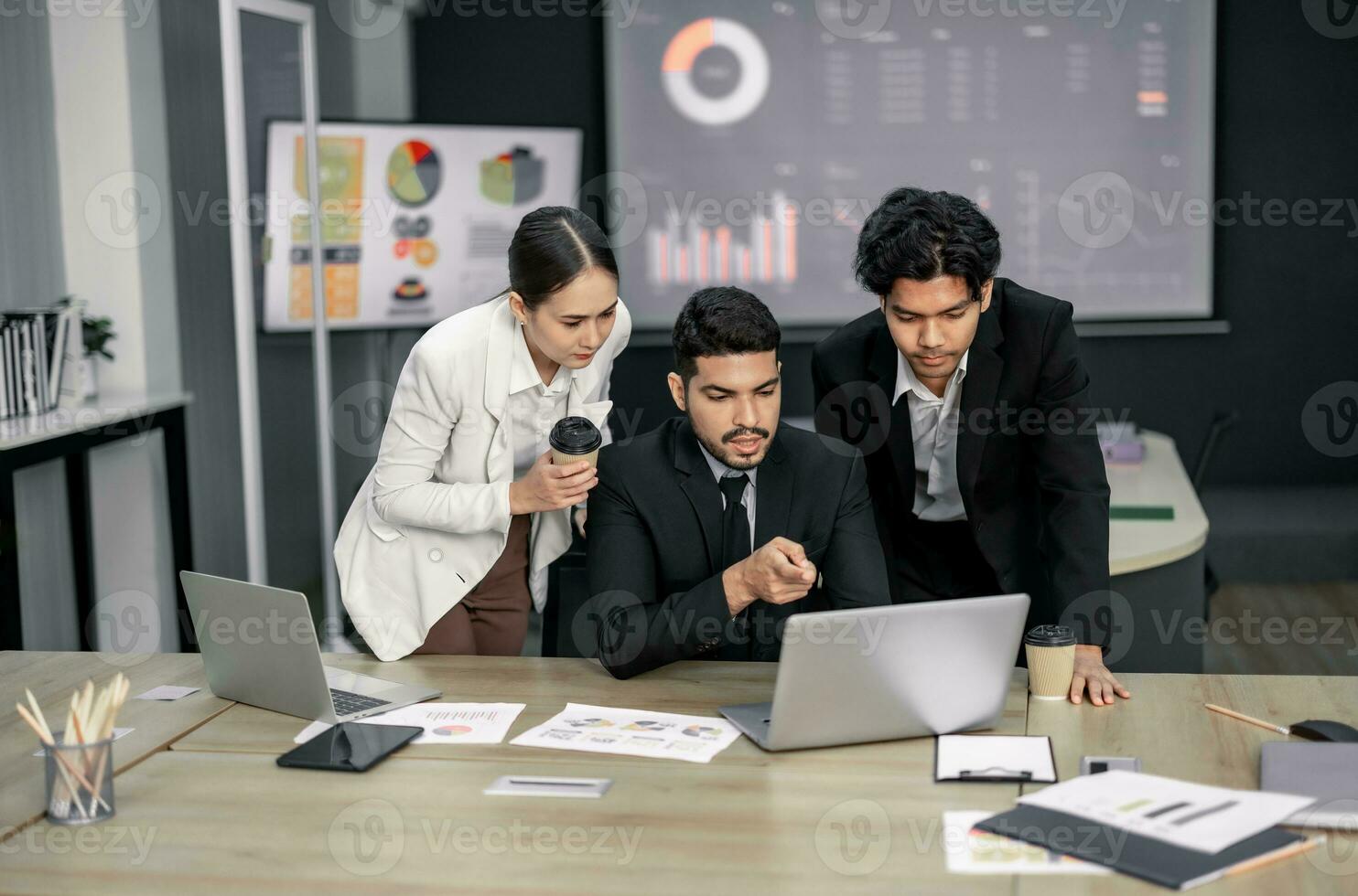 Financial advisors collaborate to assess a company's financial performance using data from its operational activities. Team members work together in a discussions meeting to develop a business plan. photo