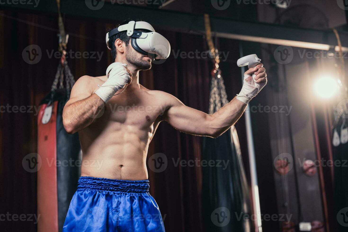 Professional boxer wear virtual reality headsets to engage in immersive boxing workouts simulations while practicing their punching techniques. Live, customized training sessions with boxing coach photo