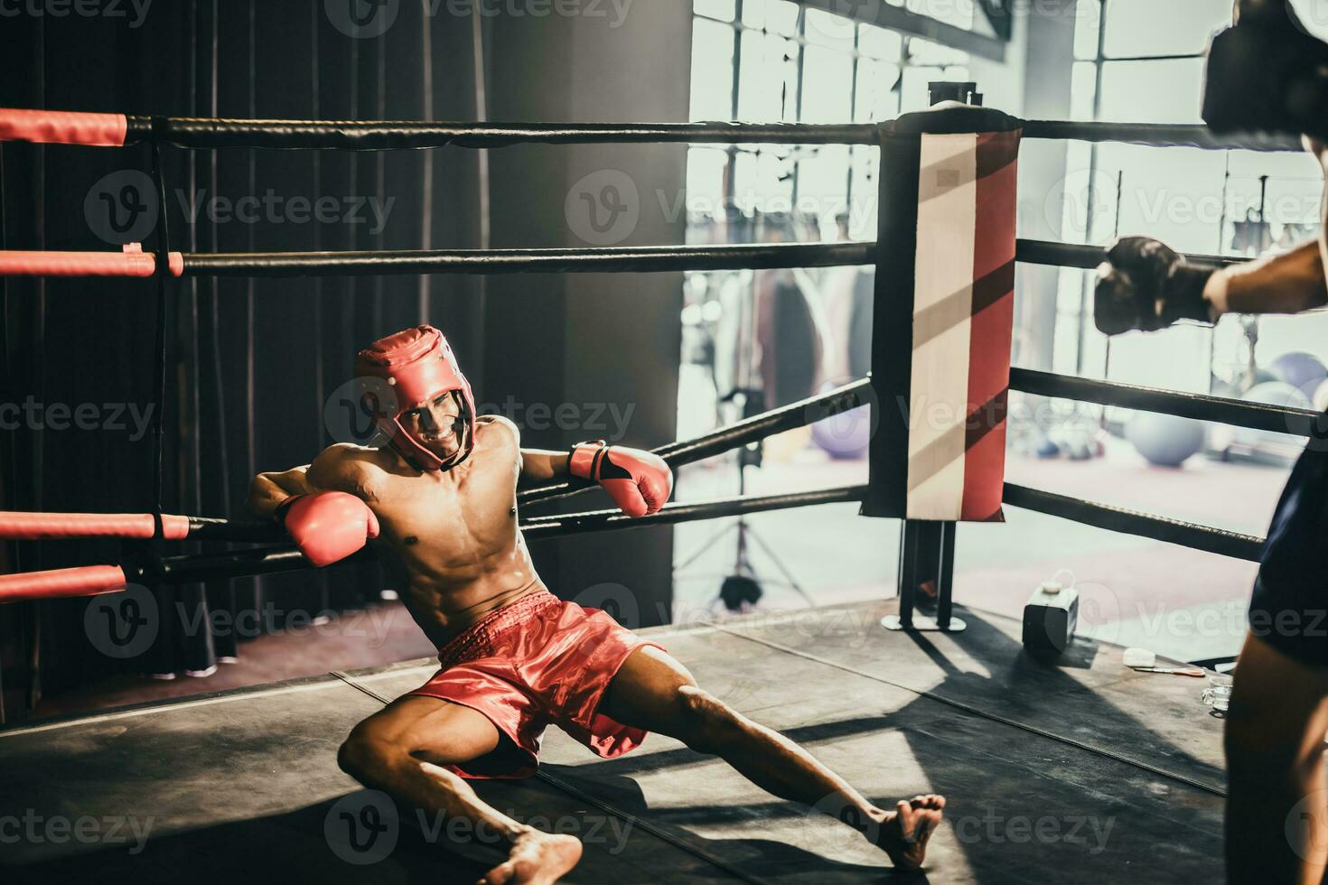 Boxer use various punch combinations, including the jab, hook, uppercut, cross, swing, straight. Getting in close to make opponent on ropes and knockout. Boxing champions win the round in boxing ring photo