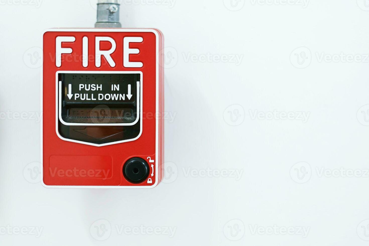 Manual pull fire alarm switch safety system box installed and fire extinguisher on white wall background. photo