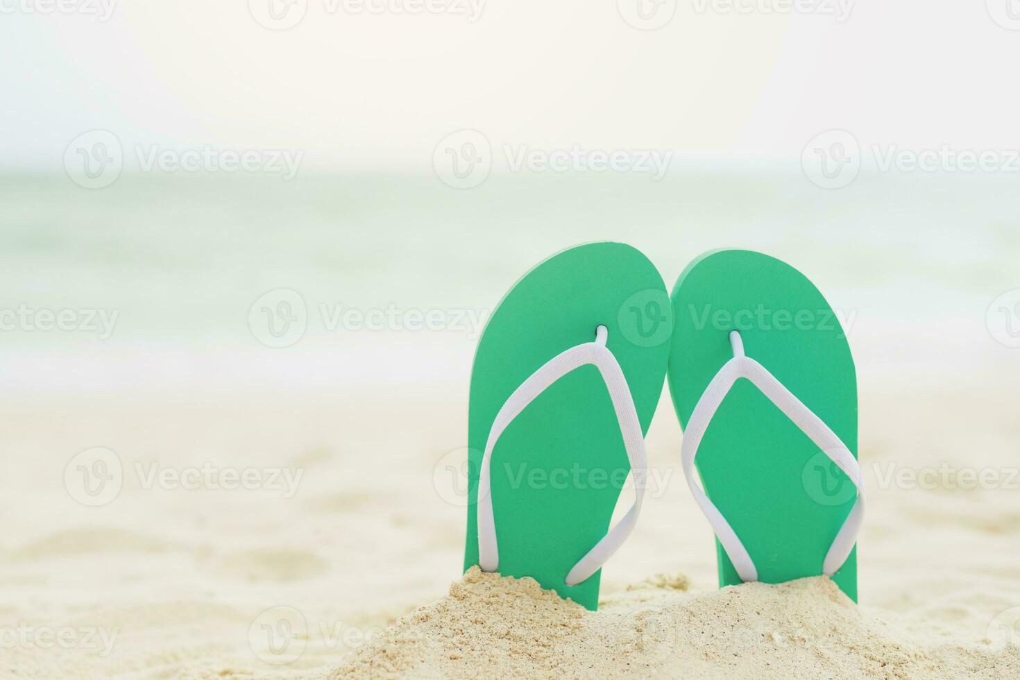 sea on the beach Footprint  people on the sand and slipper of feet in sandals shoes on beach sands background. travel holidays concept. photo