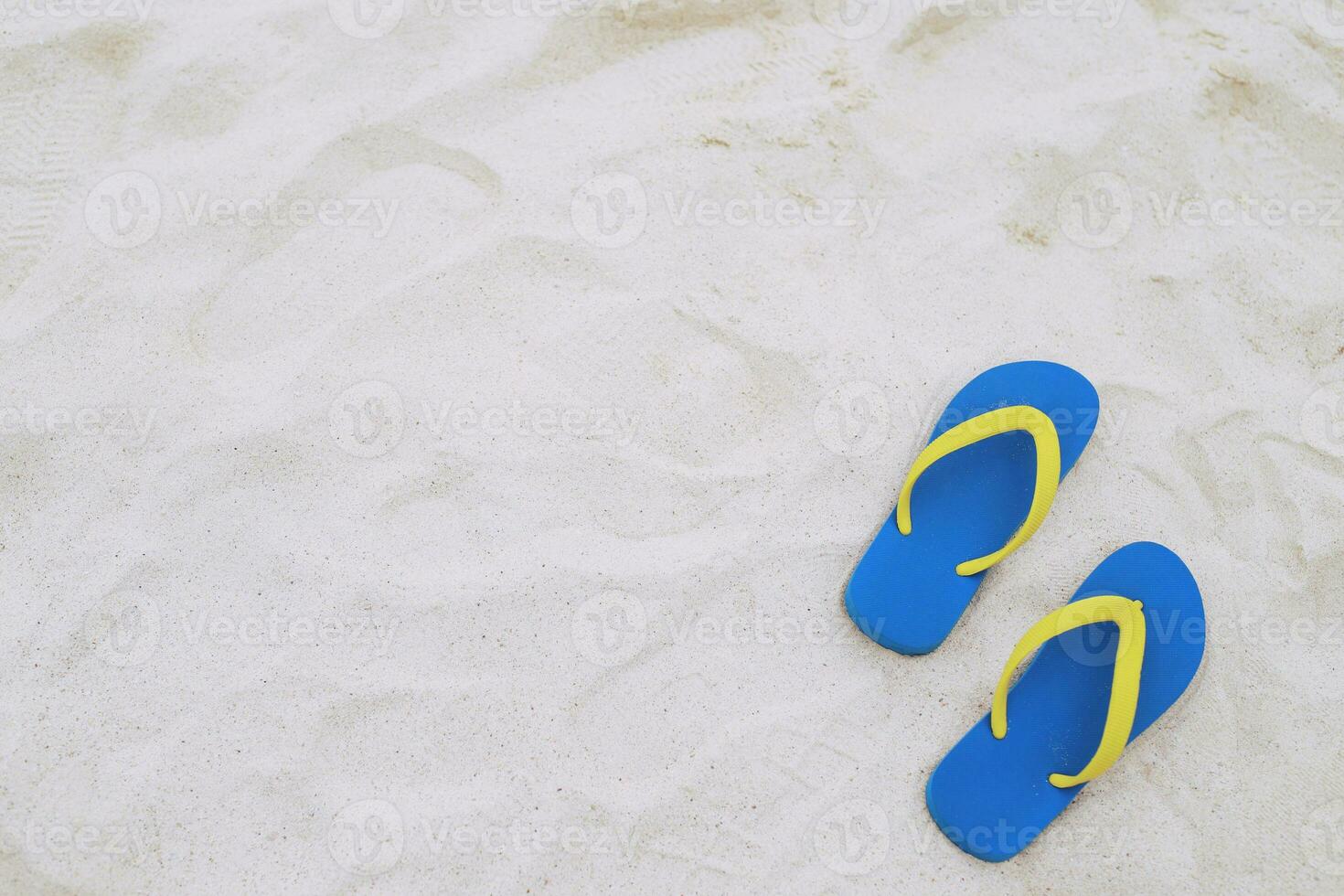 sea on the beach Footprint  people on the sand and slipper of feet in sandals shoes on beach sands background. travel holidays concept. photo