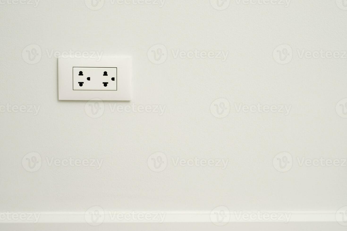 Electrical power socket plug outlet on concrete white wall. photo