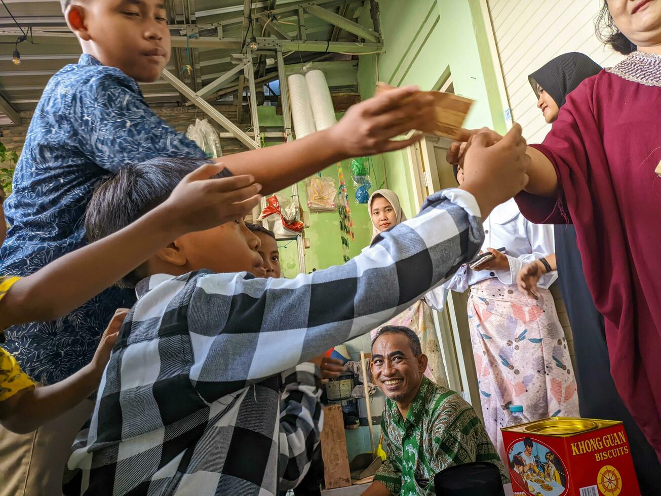Blitar, indonesia - april, 2023 - a view of young children fighting over money for Eid al-Fitr in Surabaya, Indonesia photo