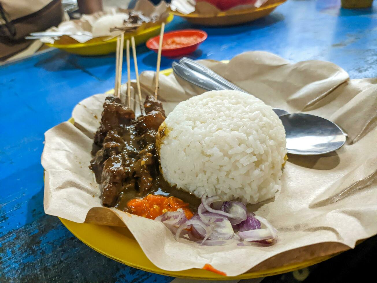 a portion of delicious sate kambing or mutton satay. Indonesian special food photo