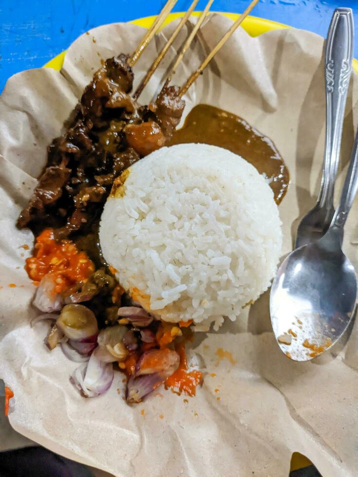 a portion of delicious sate kambing or mutton satay. Indonesian special food photo