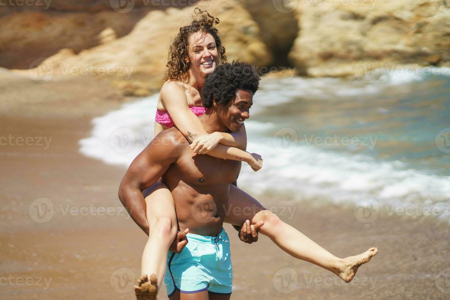 Free Photo  Man giving piggyback ride to woman on the beach