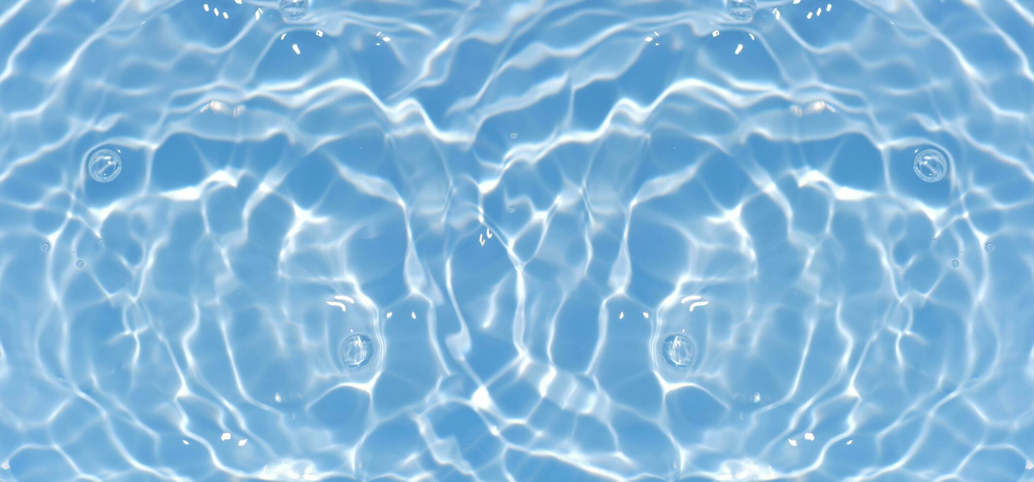 Blue water with ripples on the surface. Defocus blurred transparent blue colored clear calm water surface texture with splashes and bubbles. Water waves with shining pattern texture background. photo