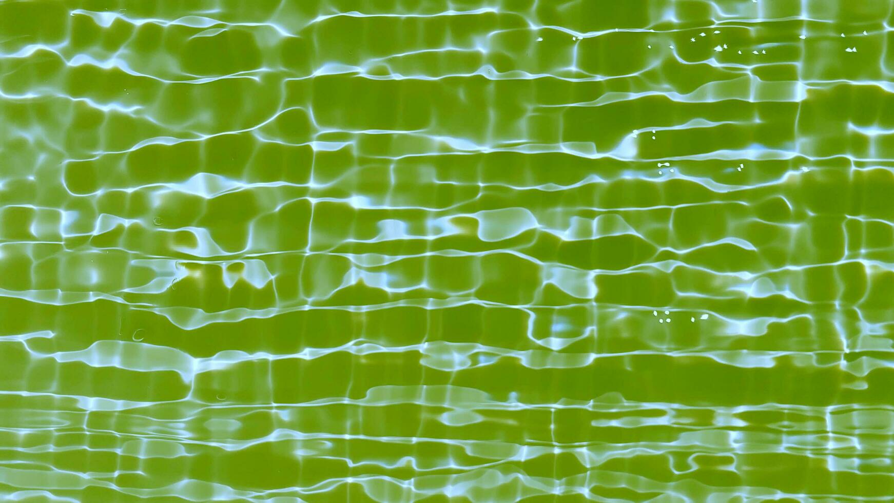 Blue water with ripples on the surface. Defocus blurred transparent blue colored clear calm water surface texture with splashes and bubbles. Water waves with shining pattern texture background. photo