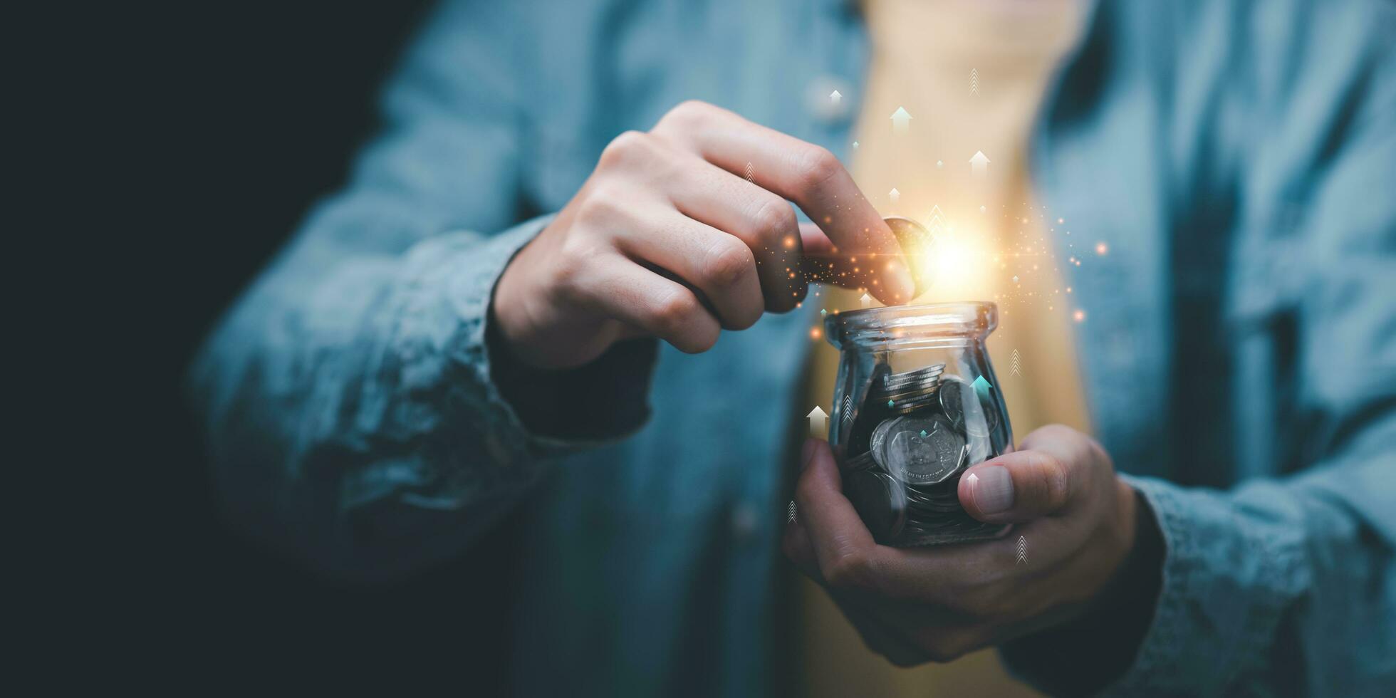 man putting coins into jar , concept of finance and investment ,profit growth ,bank interest management ,saving for retirement ,high return investment ,risk management ,Stock and currency fund photo