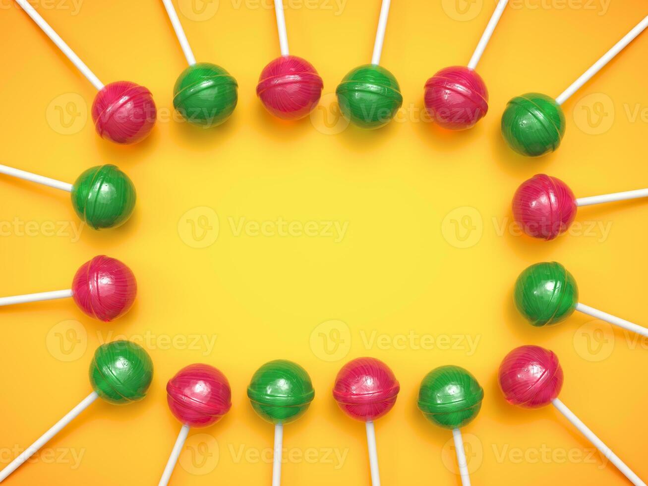 Sweet red and green lollipops arranged in frame on bright yellow