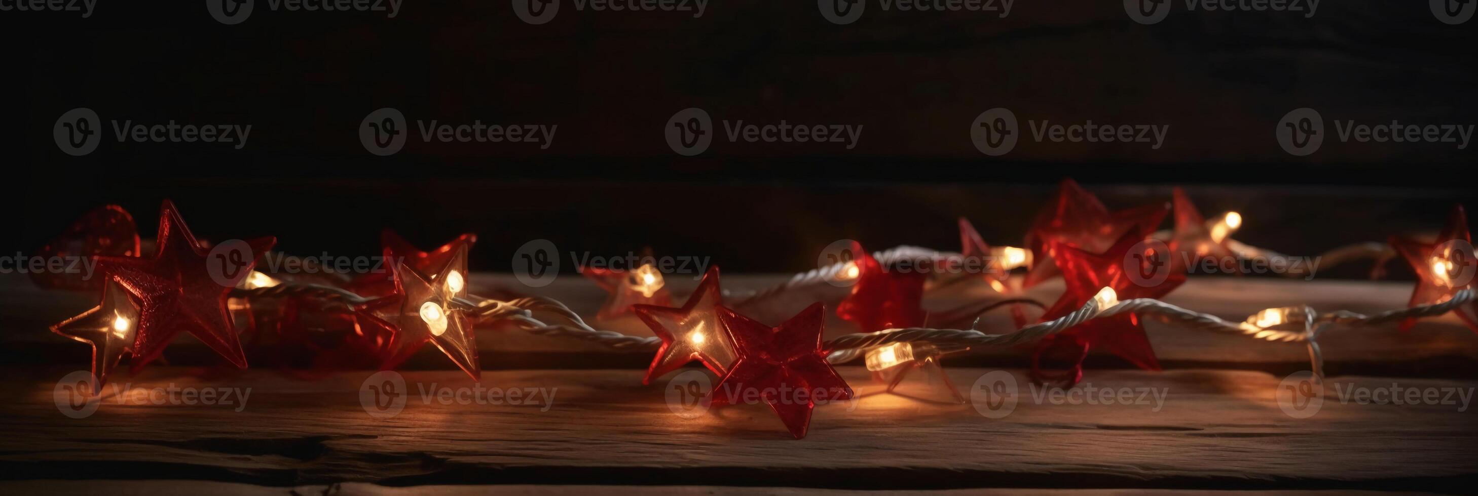 Christmas background with blue light luminous garlands and red stars on a white wooden background with copy space. photo