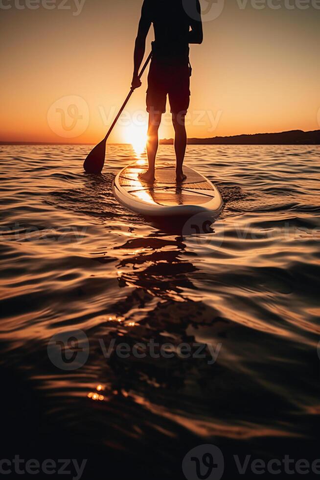 Stand up paddle boarding on quiet sea. photo